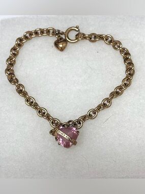Juicy Couture Heart Wish Bracelet featuring a gold-tone chain and a pink crystal